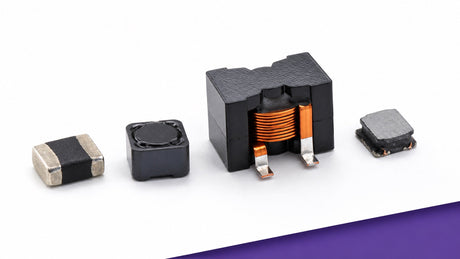 Four Allied Components International power inductors arranged on a white engineering work surface